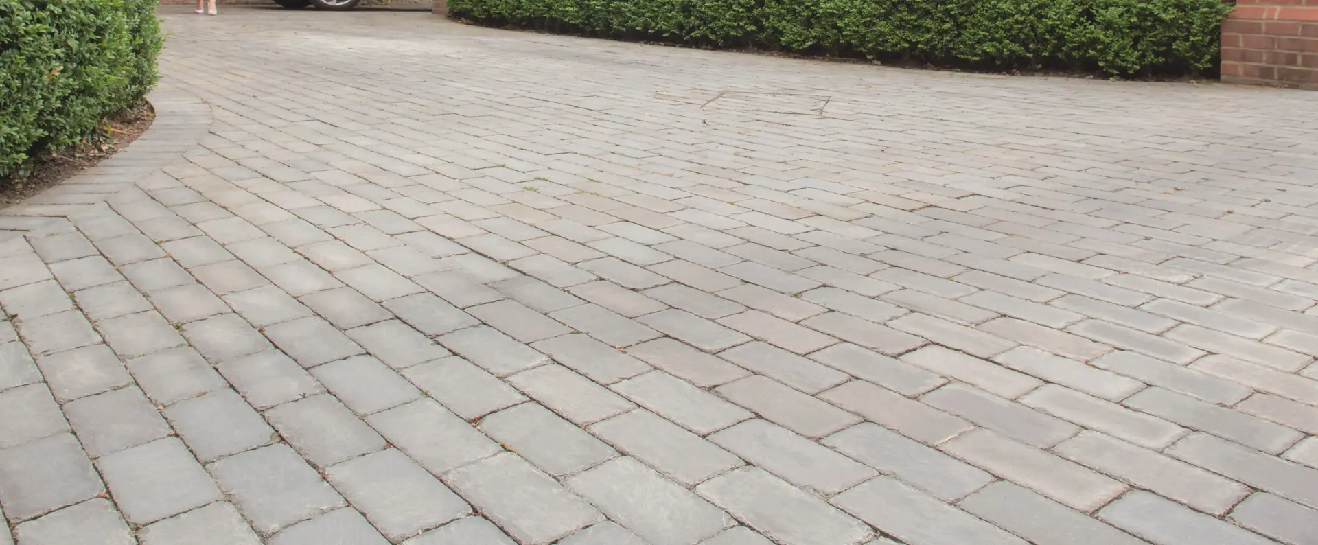 Marshalls Natural Stone Setts driveway with a female and a car in the background 