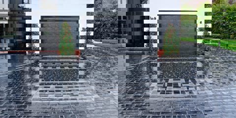 Marshalls Drivesys Riven driveway paving in front of a modern white house