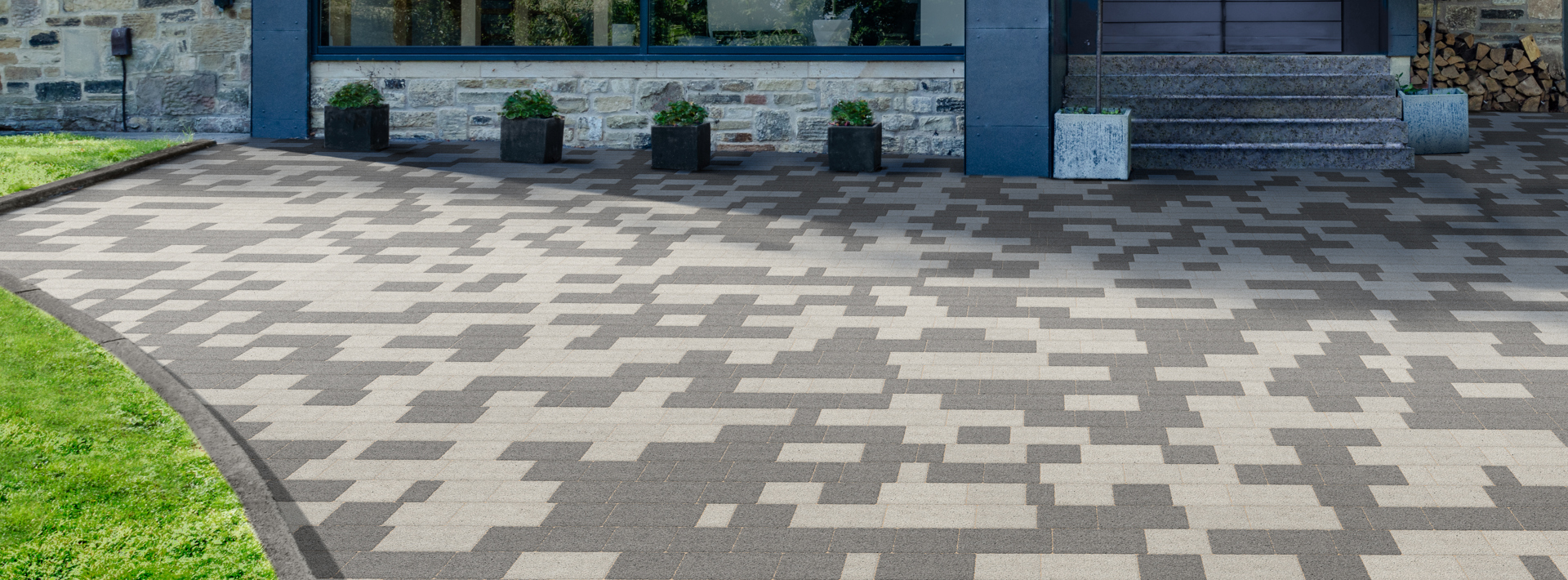Marshalls Modal X paving in a silver grey mix laid on a driveway infront of a modern glass front house