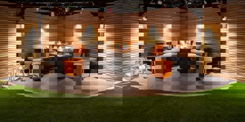 Marshalls Arrento paving laid in a garden with modern grey garden seating at night