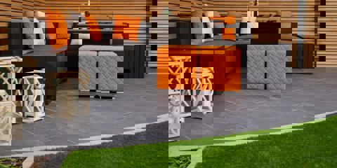 Marshalls Symphony Planks paving laid in a garden with modern grey garden furniture