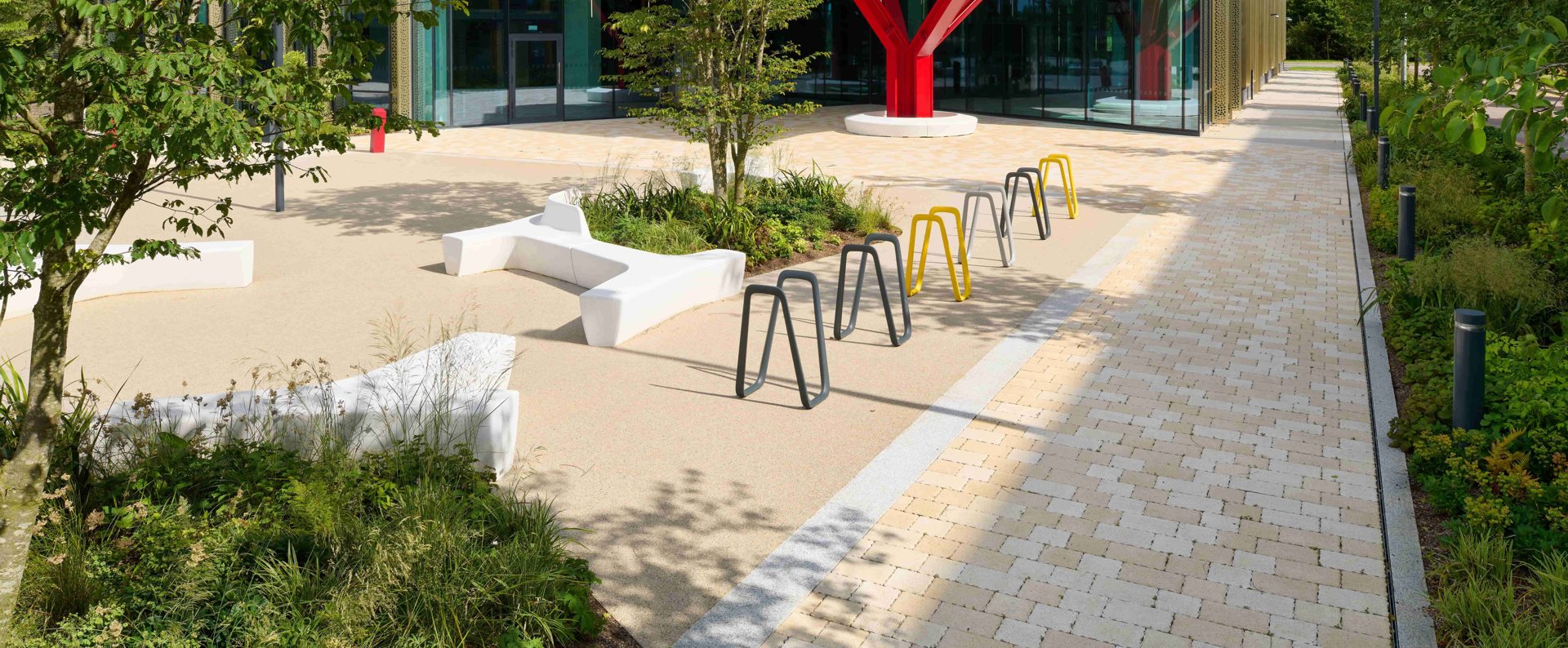 Modal X paving laid on a pathway next to yellow and grey street furniture