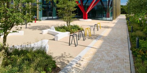 Modal X paving laid on a pathway next to yellow and grey street furniture