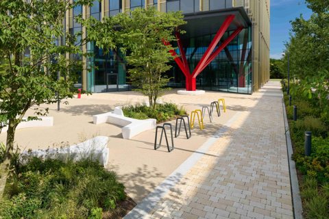 Modal X paving laid on a pathway next to yellow and grey street furniture
