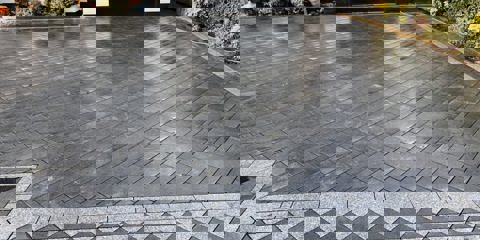 Marshalls Sawn Granite setts in light and dark laid on a driveway