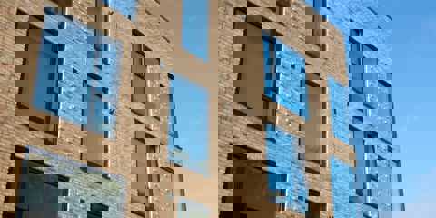 A block of flats with windows built using Marshalls Glencoe Vintage Stock Facing Brick