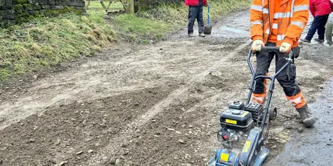 Staff on-site preparing the road 