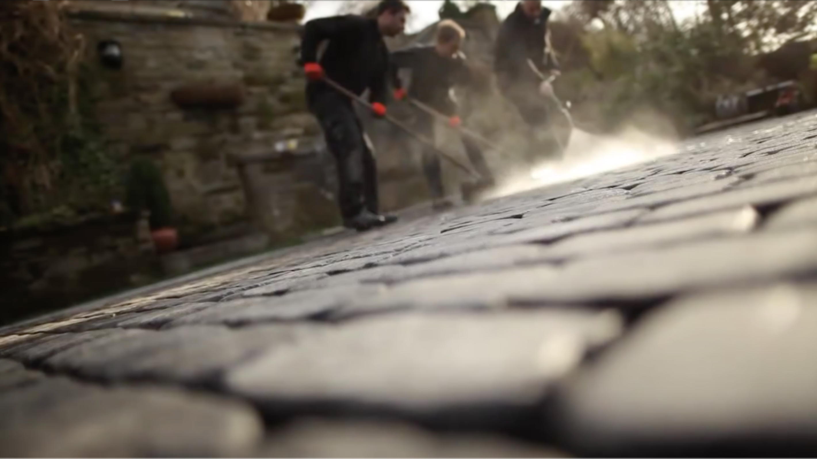 Workers cleaning Drivesys paving