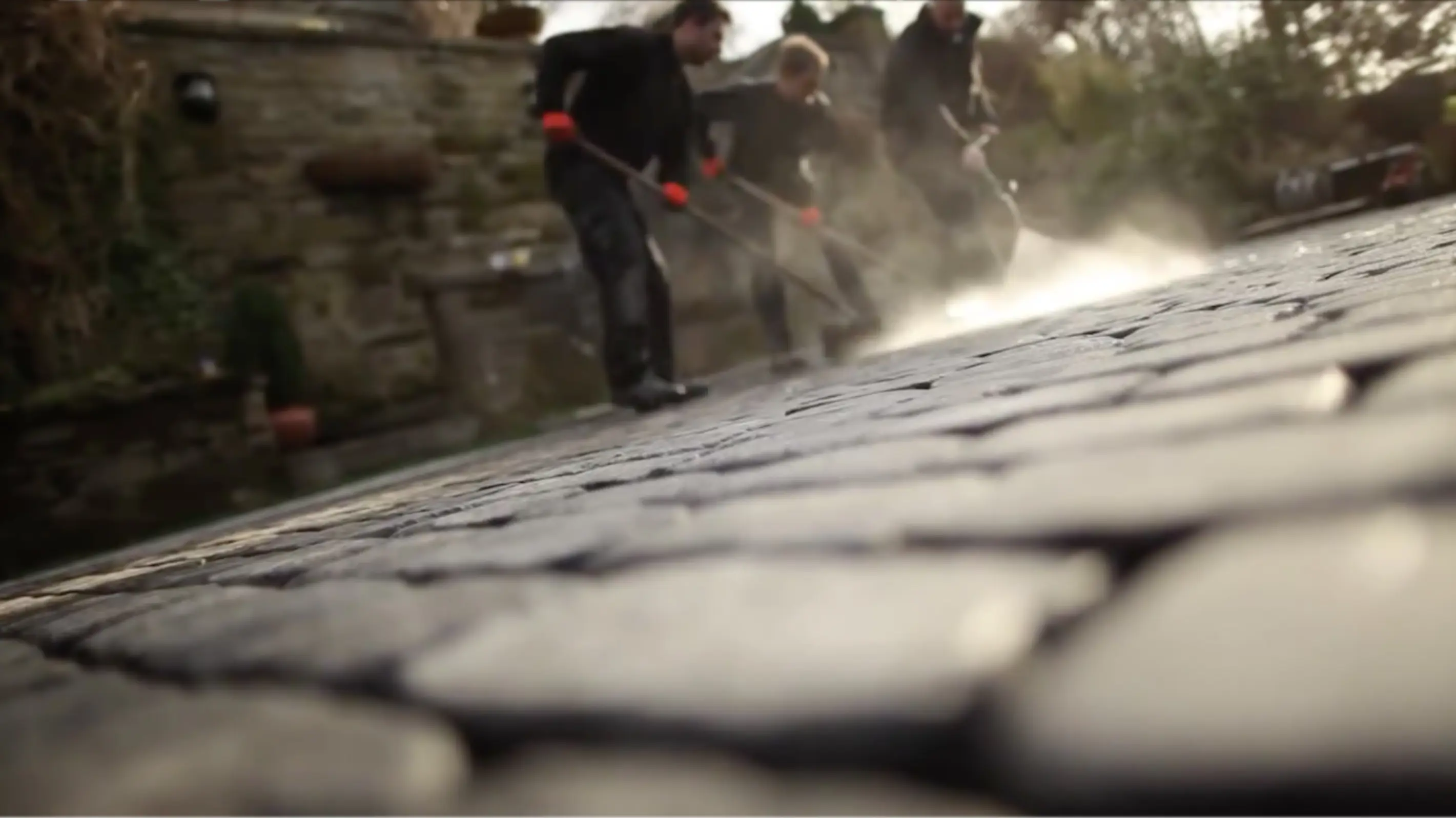 Workers cleaning Drivesys paving