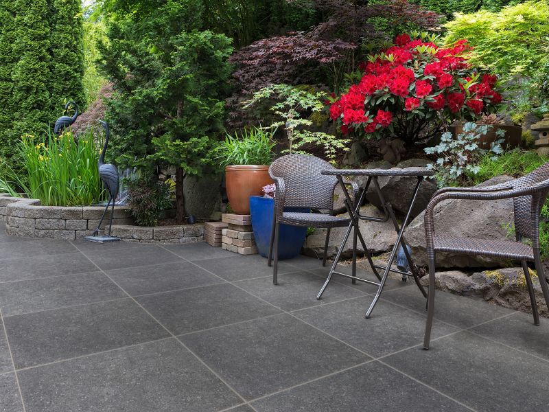A peaceful garden space with seating and a water feature