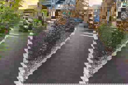 Black car parked on porcelain driveway