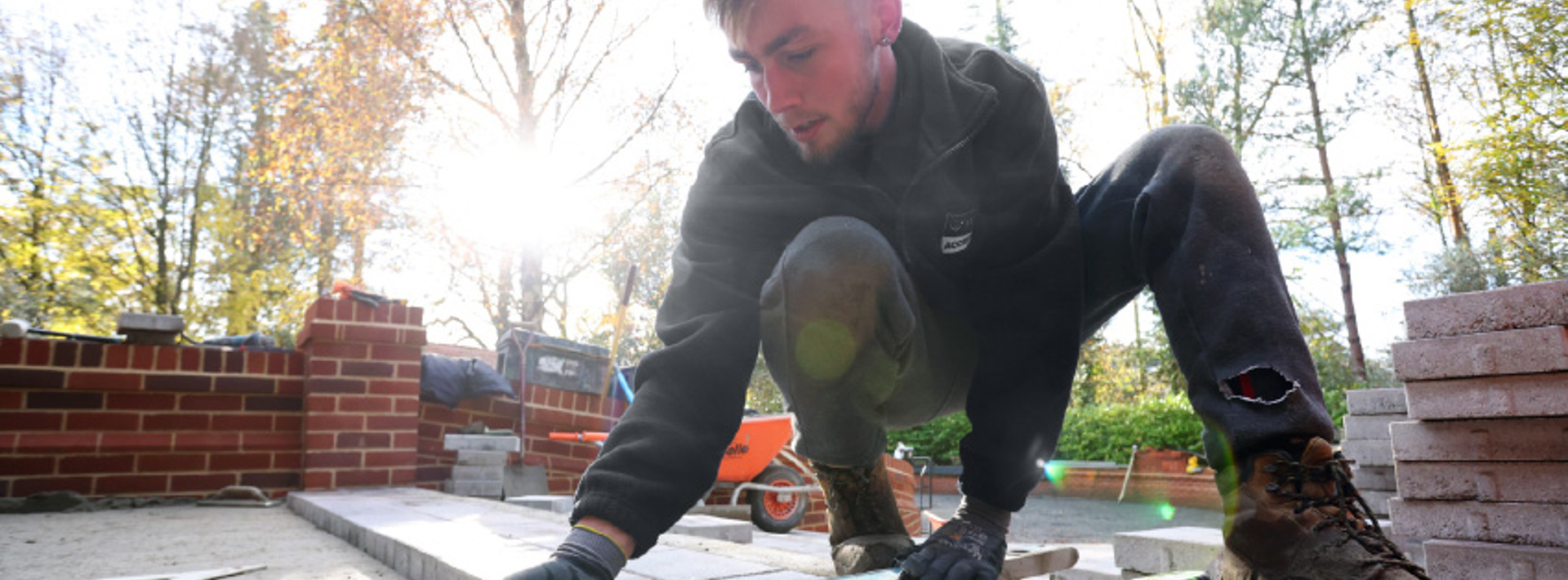 An installer in Marshalls accredited workwear laying a driveway
