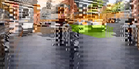 Marshalls Arrento garden paving with garden furniture in the background and a grassed area