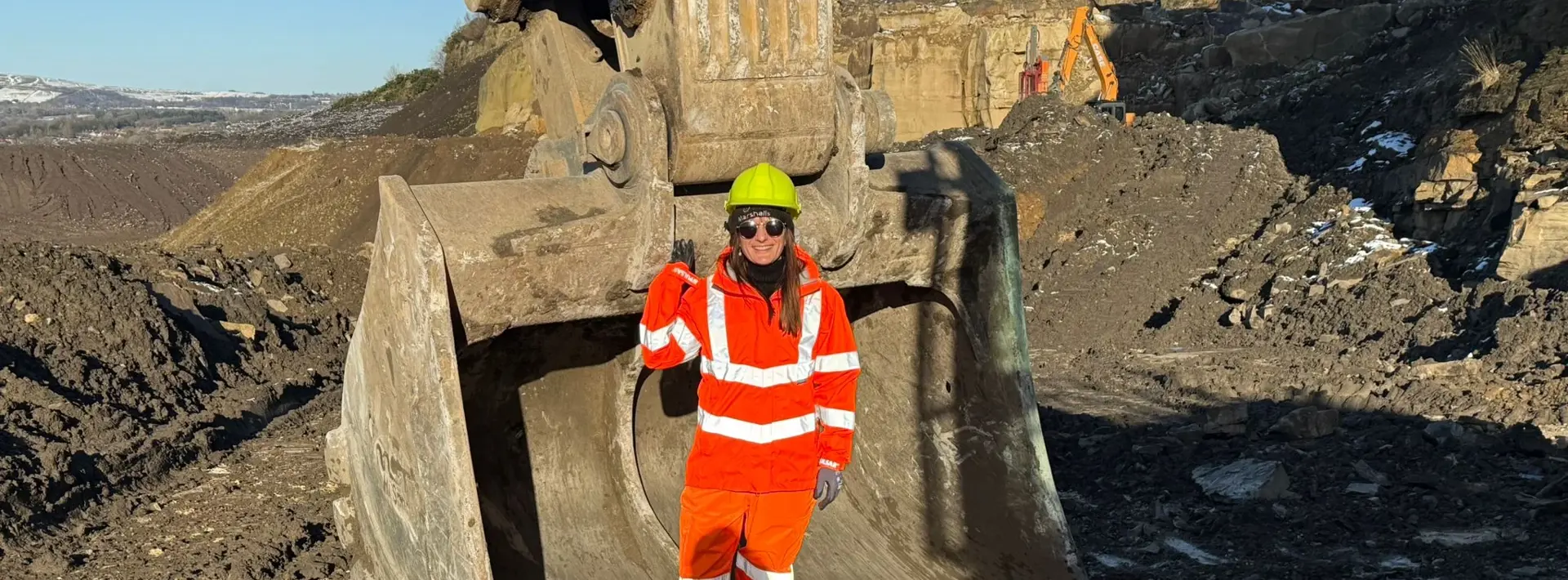 Marshalls members of staff stood on-site in front of a digger