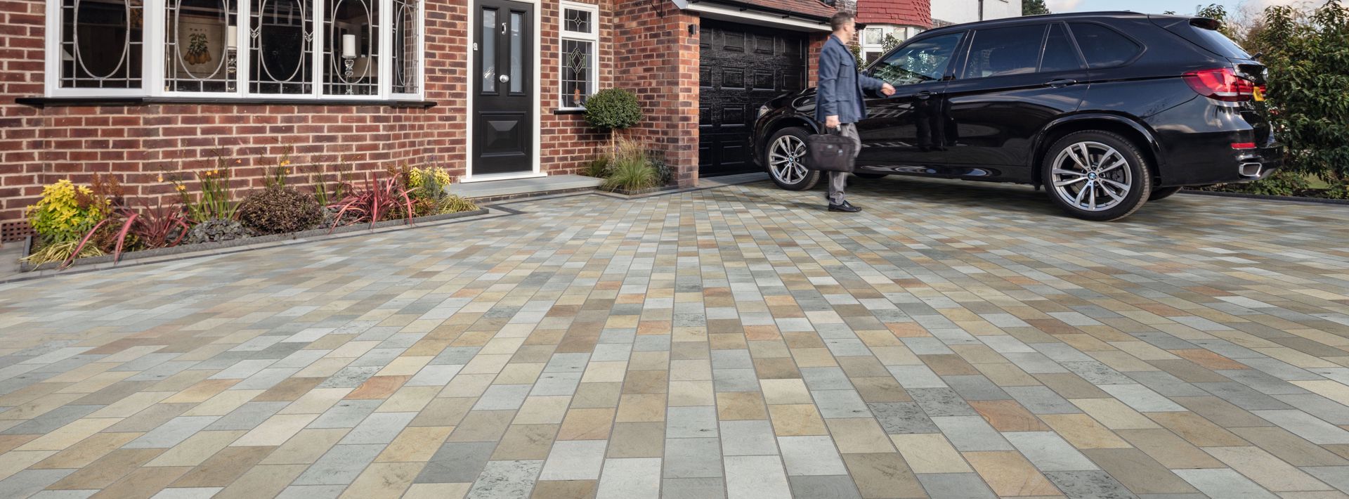 Marshalls Scoutmoor Setts block paving laid on a driveway and the homeowner is getting into their black car