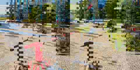 Modal X paving laid underneath a red and white safety barrier