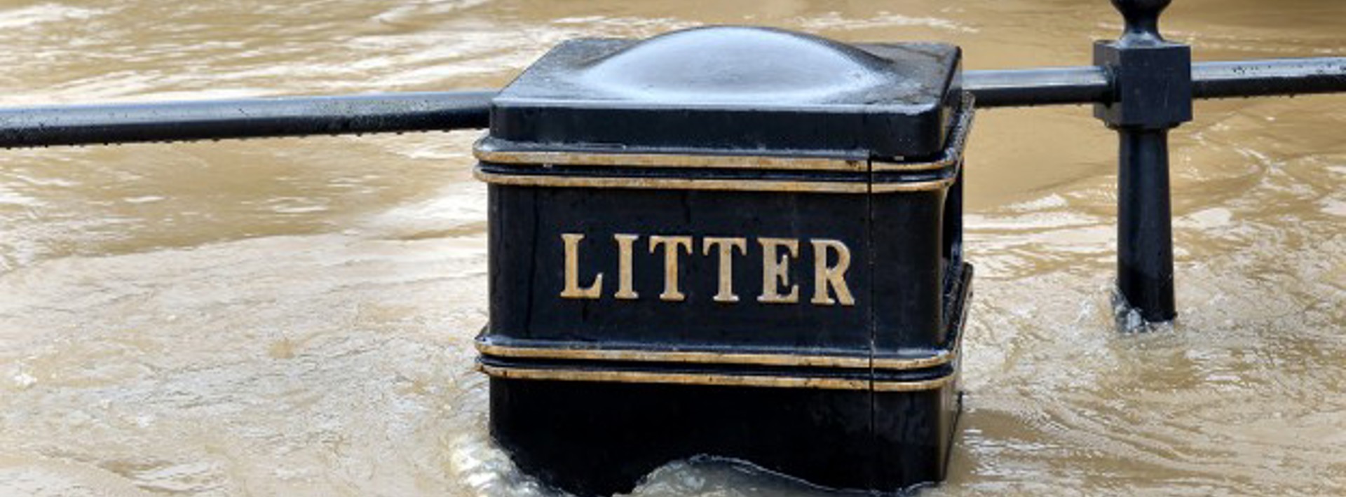 A litter bin underwater with flooding