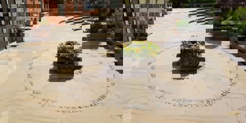 Marshalls Sawn Versuro paving and a circle feature laid in a modern garden