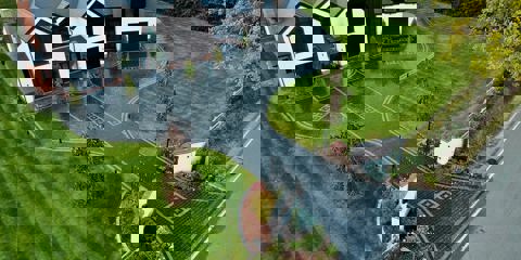 An aerial view of Marshalls Drivesys Riven paving laid on a driveway of a modern white house